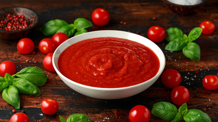 Homemade tomato Passata in white bowl on wooden table