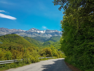 Fototapeta premium spring in mountain Tzoumerka green hills blue sky,village Lepiana , Arta perfecture Greece