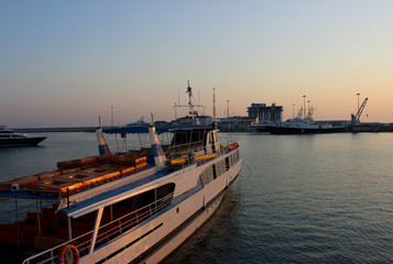 Navy pier and dock. White boats and ships. Twilight sunset sky. Beautiful water. Warm summer.