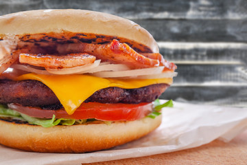 fresh flavored burger with juicy cutlet and fried bacon