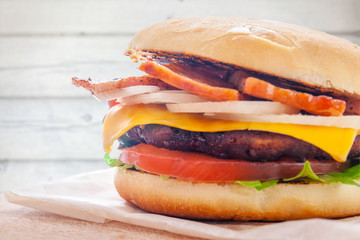 fresh flavored burger with juicy cutlet and fried bacon