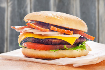 fresh flavored burger with juicy cutlet and fried bacon