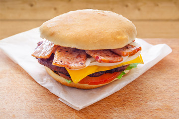 fresh flavored burger with juicy cutlet and fried bacon