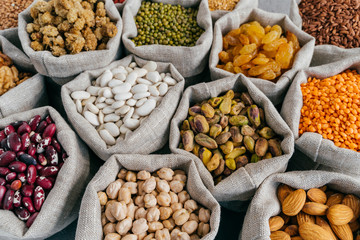 Various types of dried fruit and cereals at farmers market. Mung bean, almond, mulberry, garbanzo, raisins. Close up shot