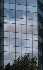 Beautiful photos of modern buildings under blue sky. Sky reflecting in windows of office building