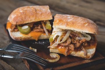 Big sandwich with meat, onions and cheddar cheese