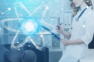 Woman scientist in office, atom hologram
