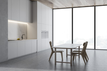 Loft concrete kitchen corner with wooden table