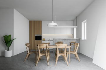 White and wooden kitchen with table