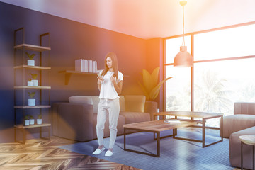 Woman in blue living room with sofas