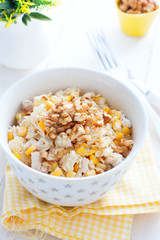 Salad with corn and pineapples in a white bowl, selective focus