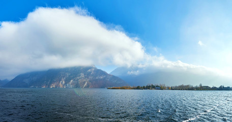 Mountain lake Traunsee with fog and clouds in Austria, Salzkammergut region.