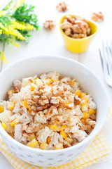 Salad with corn and pineapples in a white bowl, selective focus