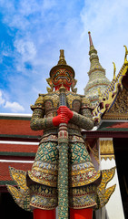Fototapeta premium Wat Phra Kaew or Temple of Emerald Buddha, Guardian statues and Grand palace located within the grounds of the Grand Palace in Bangkok is Thailand’s most sacred temple and pilgrimage site for Thai