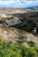 Fototapeta na wymiar The park of the Aliano gullies, mountains of clay that surround the landscape of the Aliano valleys. A municipality of Matera where it seems to be on another planet. 
