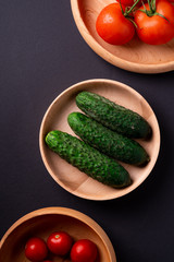 Tomato and cucumber vegetables on wooden table close up top view