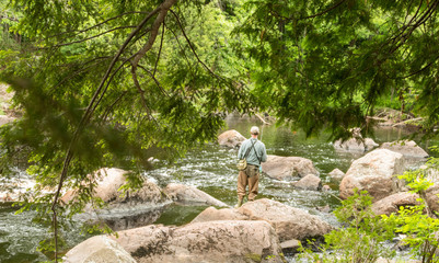 Man fishing in a rocky river
