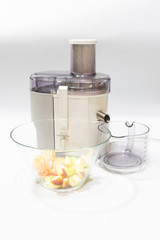 Modern electric juicer  various fruit and glass of freshly made juice  healthy lifestyle concept