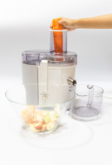 Modern electric juicer  various fruit and glass of freshly made juice  healthy lifestyle concept