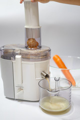 Modern electric juicer  various fruit and glass of freshly made juice  healthy lifestyle concept