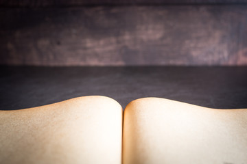 Old book open on desk, selective focus