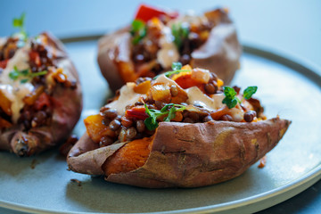 Sweet potatoes with spicy lentils, yellow pepper and tomato filling, thyme, garlic flowers and chipotle sour cream 
