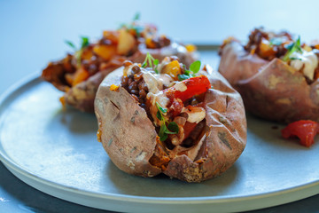 Sweet potatoes with spicy lentils, yellow pepper and tomato filling, thyme, garlic flowers and chipotle sour cream 