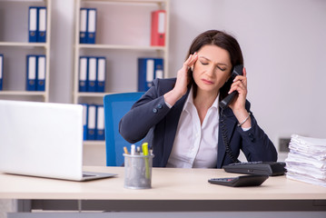 Middle-aged female employee suffering in the office 