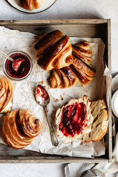 Homemade croissants with jam into wooden box