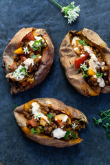 Sweet potatoes with spicy lentils, yellow pepper and tomato filling, thyme, garlic flowers and chipotle sour cream 