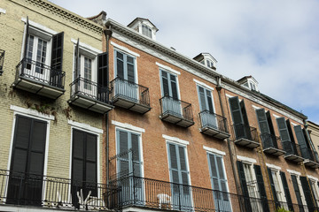 Colorful brick buildings with decorative metal balconies in urban area
