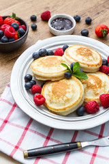 Tasty fluffy pancakes with berries