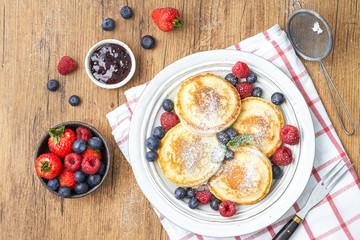 Tasty fluffy pancakes with berries