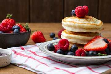 Tasty fluffy pancakes with berries