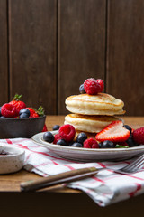 Tasty fluffy pancakes with berries