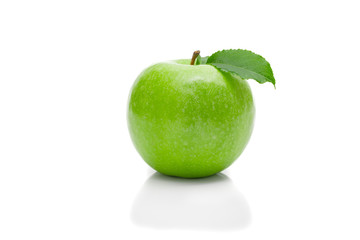 Ripe green apple with leaf on a white background .