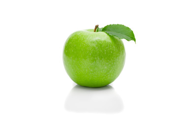 Ripe green apple with leaf on a white background .