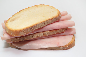 panino a fette italiano con prosciutto cotto su sfondo bianco, italian sliced sandwich with cooked ham on white background