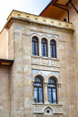 Clean shoot of stone masonry old government building facade with turkish architectural elements