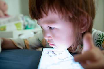 child draws on a smartphone