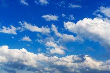 Naklejka na ściany i meble Clouds against blue sky. Dramatic background.