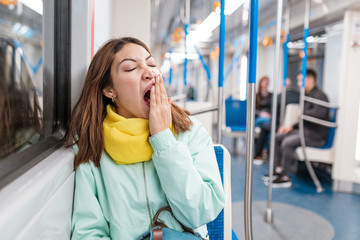 The girl suffering from insomnia sleeps or taking a nap in the subway while tired goes home from...