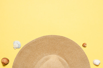 Fototapeta na wymiar Summer vacation concept flat lay. Hat and seashells on yellow background. Copy spase. - Image