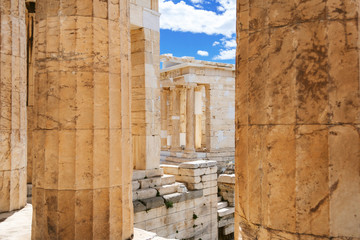 A look at the Athena Nike Temple through the columns of the Acropolis Gate. Athens. Greece.