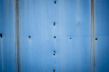 Screws on a blue rusty background