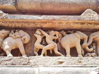 Fototapeta na wymiar The Erotic Sculptures of the Khajuraho Temples. Khajuraho Temples are among the most beautiful medieval monuments in India.