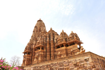 Fototapeta na wymiar Khajuraho is known for its ornate temples that are spectacular piece of human imagination, artistic creativity, magnificent architectural work and deriving spiritual peace through eroticism.