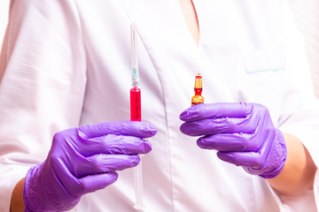 Woman hand holding syringe and ampule