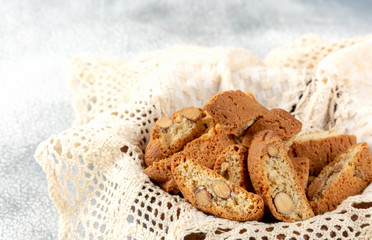 Italian cantuccini cookies in a plate with wicker napkin. Light background
