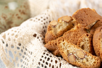 Italian cantuccini cookies in a plate with wicker napkin. Light background